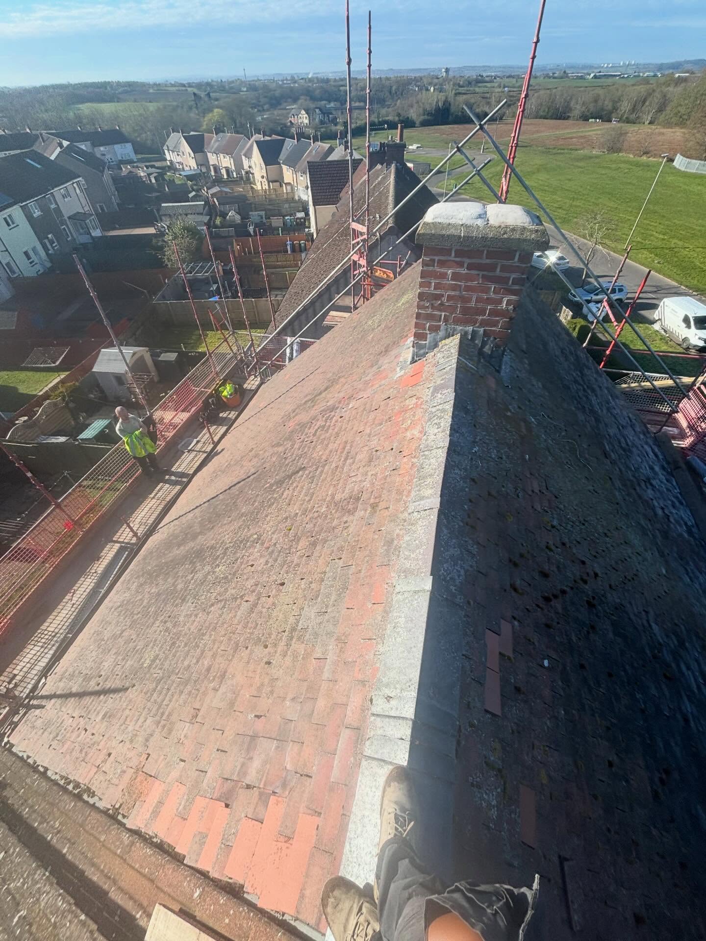 Worn tiled roof before replacement