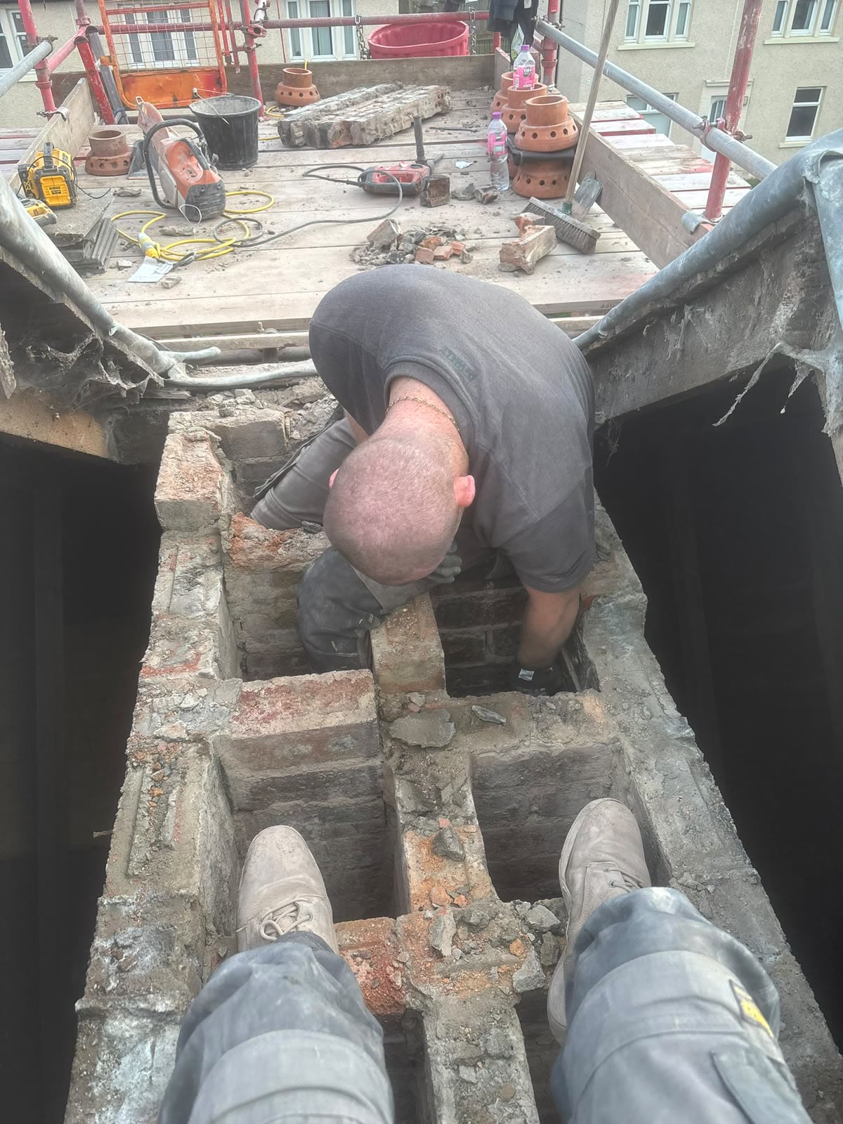 LA Roofing taking down a chimney stack brick by brick