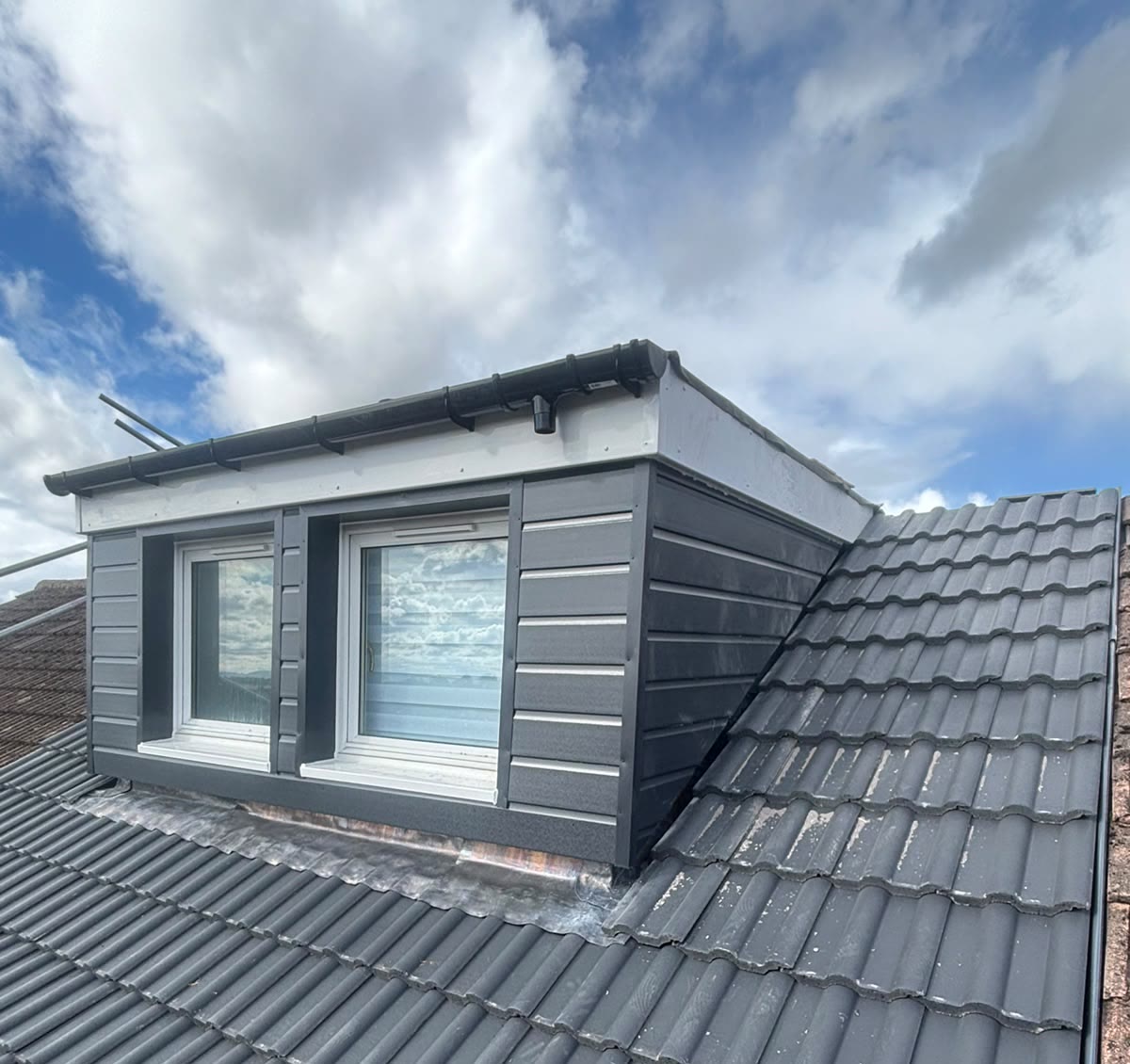 Re-tiled roof with a newly clad dormer