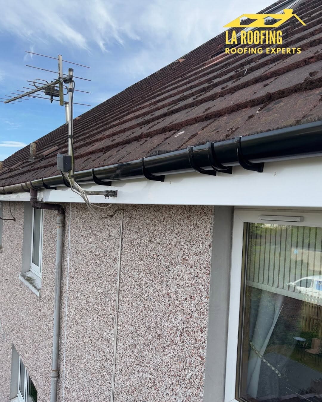 New black guttering on white roofline