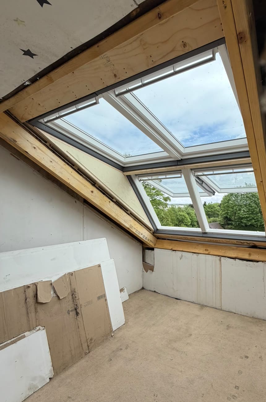 Four roof windows fitted in a loft, seen from inside